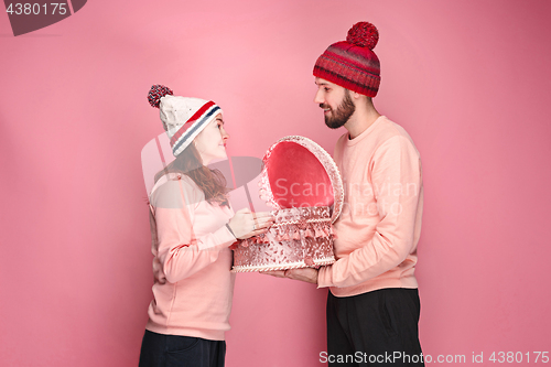 Image of Portrait of a surprised little girl with her father holding a Christmas present