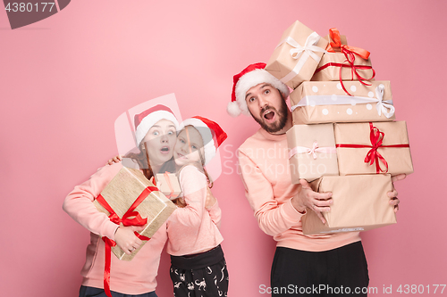 Image of Father and mother give gifts to little daughter at studio