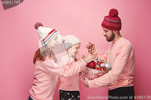 Image of Father and mother give gifts to little daughter at studio