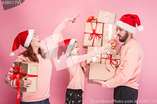 Image of Father and mother give gifts to little daughter at studio