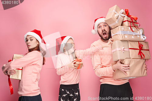 Image of Father and mother give gifts to little daughter at studio