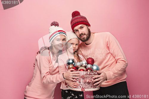 Image of Father and mother give gifts to little daughter at studio