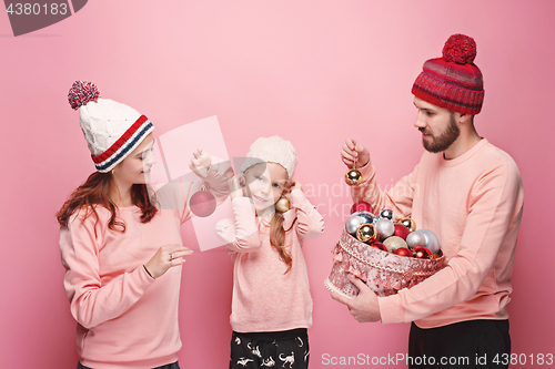 Image of Father and mother give gifts to little daughter at studio