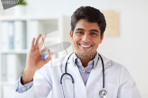 Image of happy doctor with stethoscope at clinic showing ok