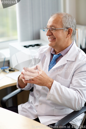 Image of happy smiling doctor at medical office in hospital