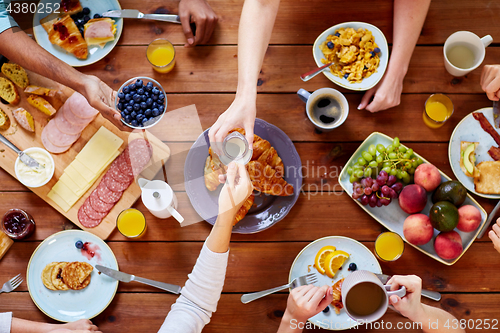 Image of people having breakfast at table with food