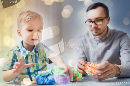 Image of father and son playing with ball clay at home