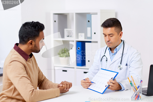 Image of happy doctor and male patient meeting at hospital