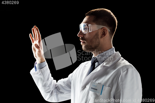Image of doctor or scientist in lab coat and safety glasses