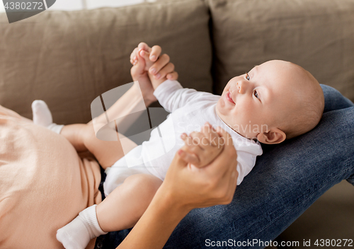 Image of happy mother with little baby boy at home