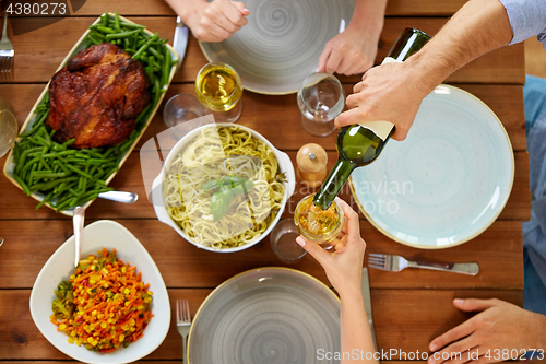 Image of group of people eating and drinking wine