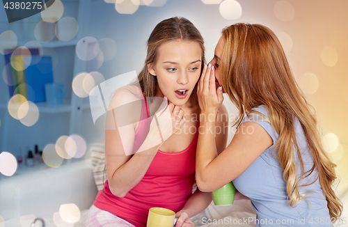 Image of young women drinking tea and gossiping at home