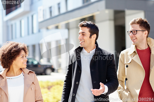 Image of office workers or friends talking on city street