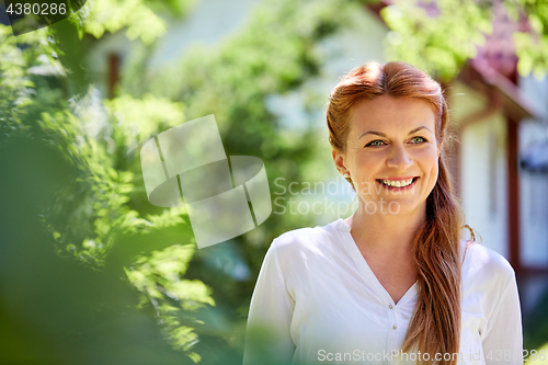 Image of happy smiling woman at summer garden