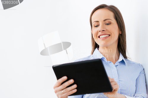 Image of businesswoman with tablet pc working at office