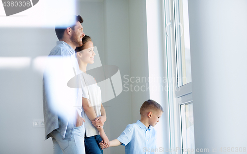 Image of happy family with child at new home or apartment