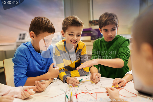 Image of happy kids with invention kit at robotics school