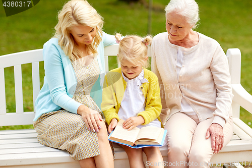 Image of woman with daughter and senior mother at park