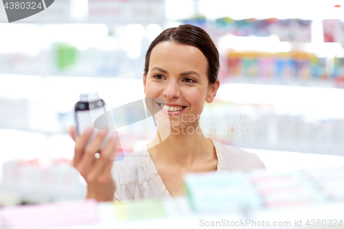 Image of female customer choosing drugs at pharmacy