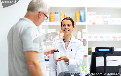 Image of apothecary and senior customer at pharmacy