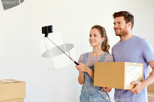 Image of happy couple with boxes moving to new home