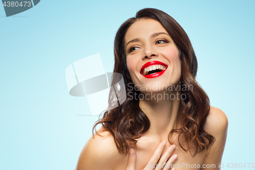 Image of beautiful laughing young woman with red lipstick