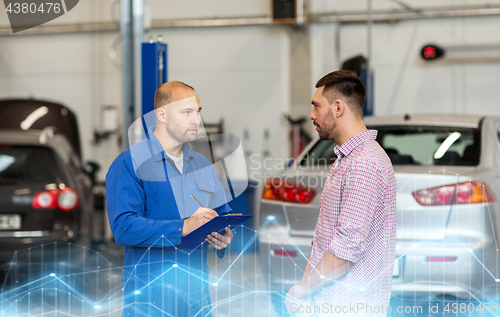 Image of auto mechanic with clipboard and man at car shop