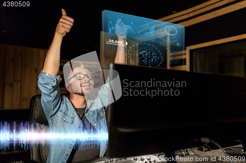 Image of man at mixing console in music recording studio