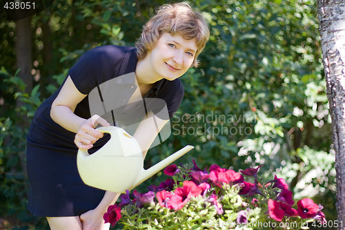 Image of woman watering flowers