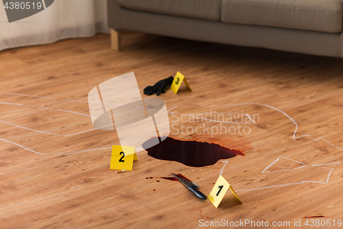 Image of chalk outline and knife in blood at crime scene