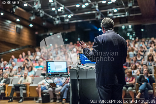 Image of Public speaker giving talk at Business Event.