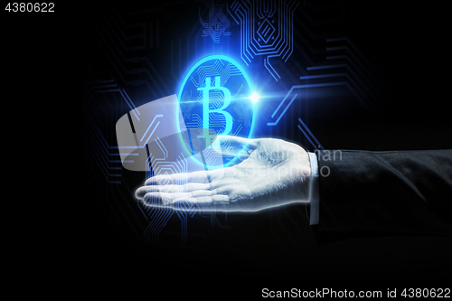 Image of close up of businessman hand with bitcoin symbol