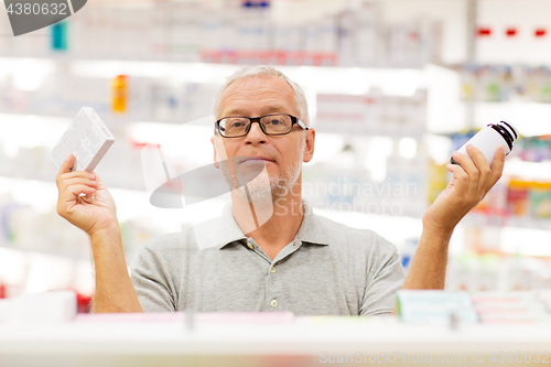 Image of senior male customer choosing drugs at pharmacy