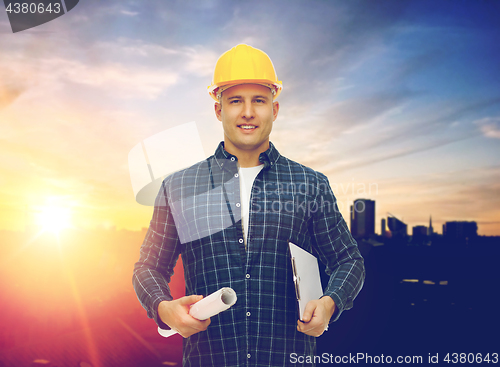 Image of builder in hard hat with blueprint and clipboard