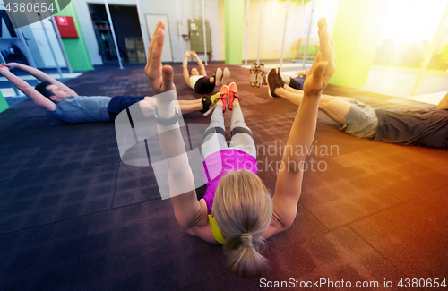 Image of group of people exercising in gym