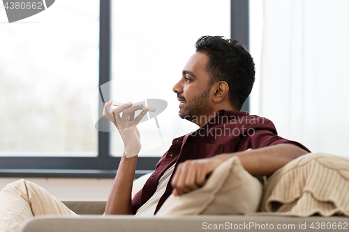 Image of man using voice command recorder on smartphone