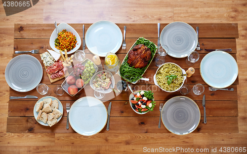 Image of various food on served wooden table