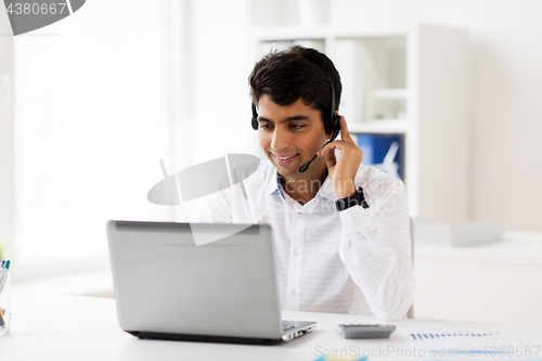 Image of businessman with headset and laptop at office