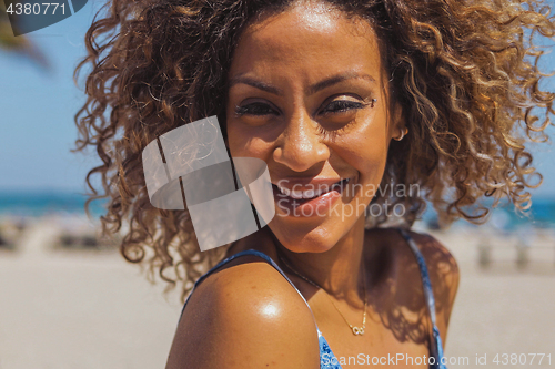 Image of Bright African American woman in tropical sunshine