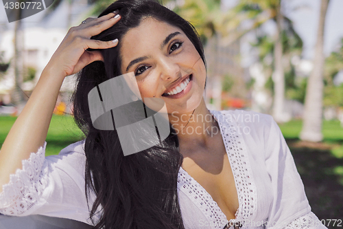 Image of Bright smiling ethnic woman in tropical park