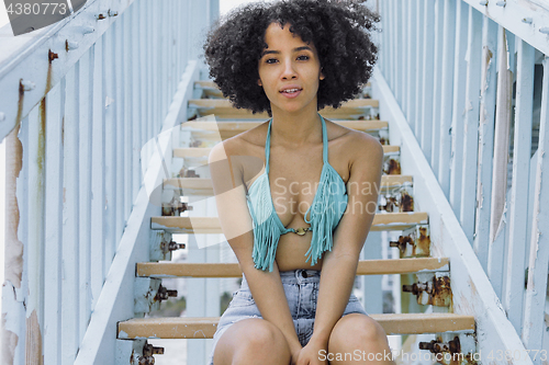 Image of Sensual black girl in bikini on stairs