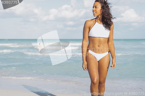 Image of Young fit black girl on seaside