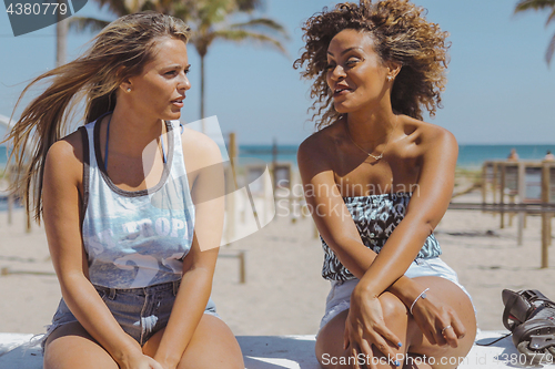 Image of Relaxed women spending time on shoreline