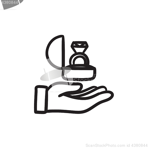 Image of Hand holding gift box with ring sketch icon.