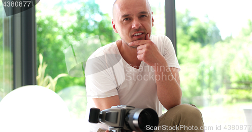 Image of Photographer takes pictures with DSLR camera