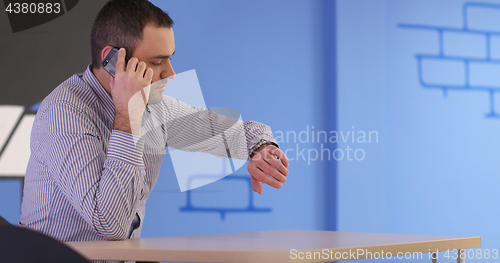 Image of Senior businessman  using cell phone at  stratup office