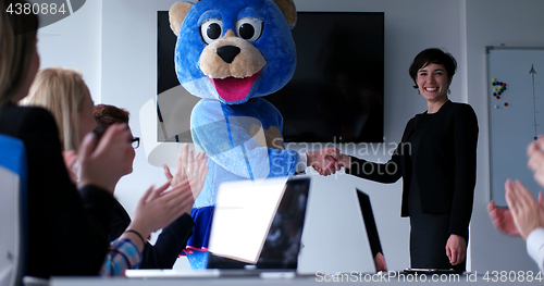 Image of boss dresed as bear having fun with business people in trendy of