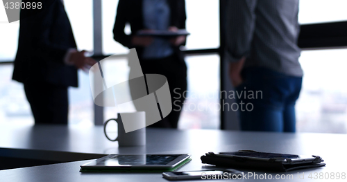 Image of tablet, mobile cell phone and cup of coffee  in office with busi