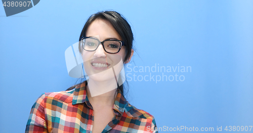 Image of woman smiling wearing on a pair of large glasses