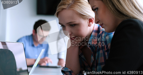 Image of group of business people having a meeting in bright office